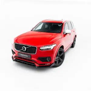 Red Volvo SUV shown from a front-left angle against a white studio background, highlighting the grille and headlights.