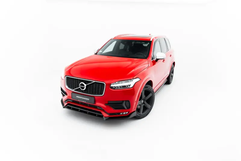 Red Volvo SUV shown from a front-left angle against a white studio background, highlighting the grille and headlights.
