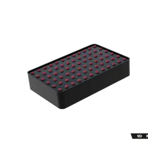 Black rectangular tray filled with evenly spaced red pills arranged in a grid, viewed from above.