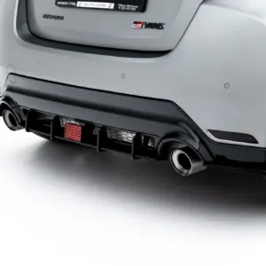 Rear view of a gray GR Yaris with diffuser, dual exhausts, and visible badge on the tailgate.