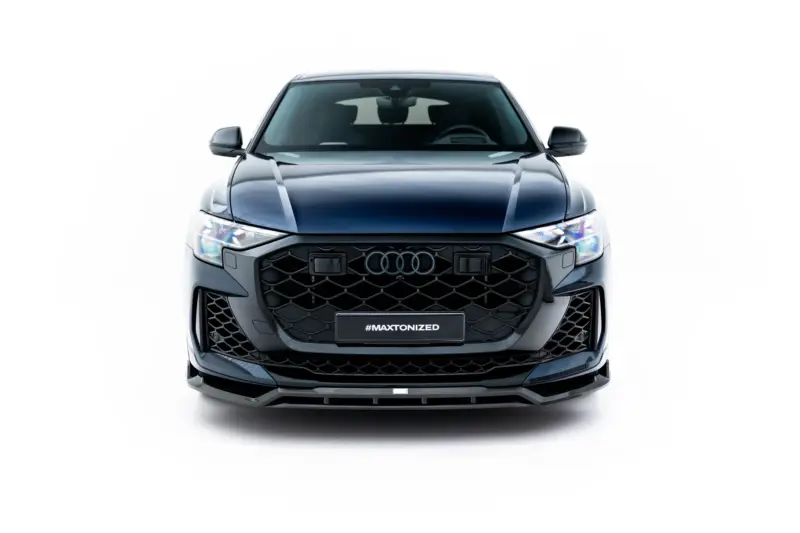 Front view of a metallic gray Audi SUV with a large black grille and '#MAXTONIZED' plate on a white background.