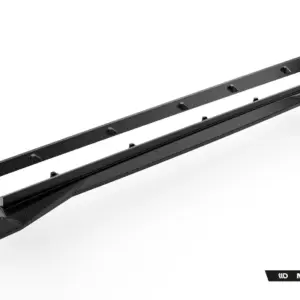 Two carbon-fiber roof rack cross bars with mounting clips laid diagonally across a white studio background (Maxton Design branding visible).
