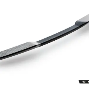 Long curved carbon fiber strip with diagonal weave on a white background, Maxton Design branding visible in the bottom-right corner.
