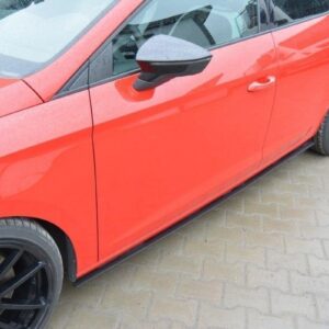 Red car side view showing front and rear doors, black alloy wheels, and a wet pavement surface nearby.