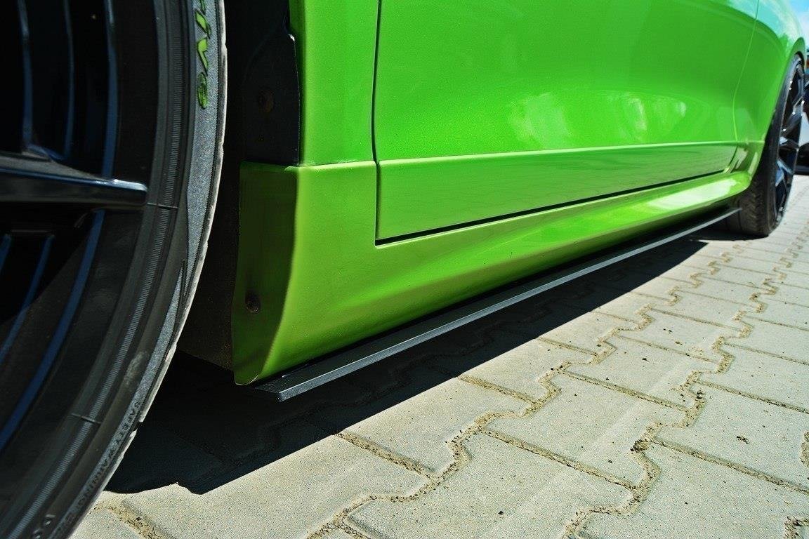 pol_po_RACING-SIDE-SKIRTS-DIFFUSERS-Volkswagen-Scirocco-R-Mk3-Mk3-Facelift-1768_1jpg - OPSHOLDERS Close-up of a bright green car's lower side panel and wheel, showing a low ground-hugging side skirt on a paved parking area