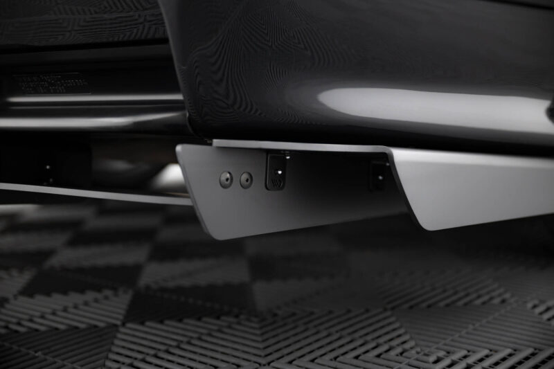pol_po_REAR-DIFFUSER-BMW-M3-3-M-Pack-Coupe-Cabrio-E36-1829_10jpg - OPSHOLDERS Close-up of a car's rear bumper and mounting plate area, showing the grey trim and small hardware underneath.