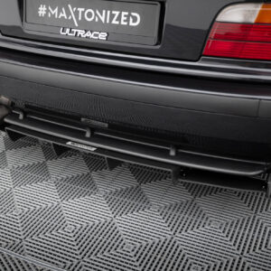 Rear view of a dark car showing dual exhaust pipes and a license plate that reads '#MAXTONIZED' with 'ULTRACE' branding below.