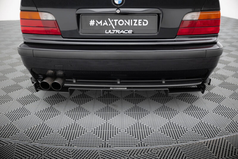 pol_po_REAR-DIFFUSER-BMW-M3-3-M-Pack-Coupe-Cabrio-E36-1829_8jpg - OPSHOLDERS Rear view of a black car showing a customized license plate reading '#MAXTONIZED' with 'ULTRACE' logo and dual exhausts beneath.