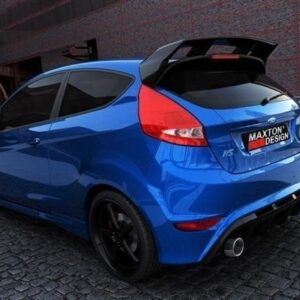 Blue sporty hatchback with Maxton Design rear diffuser and dual exhausts, parked on a cobblestone street.