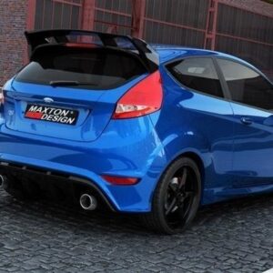 Blue hatchback with aftermarket rear spoiler and quad exhausts, parked on a cobblestone street; Maxton Design badge on the rear bumper.