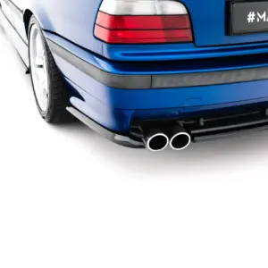 Blue car rear end with dual exhaust pipes and a license plate reading '#MAXTONIZED'