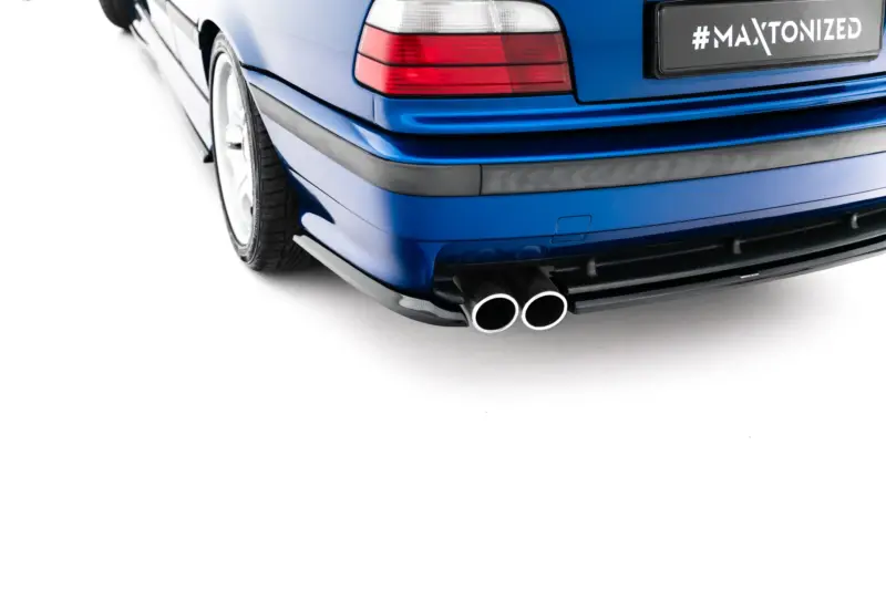 pol_po_Rear-Side-Splitters-BMW-M3-3-M-Pack-Coupe-Cabrio-E36-23876_4webp - OPSHOLDERS Blue car rear end with dual exhaust pipes and a license plate reading '#MAXTONIZED'