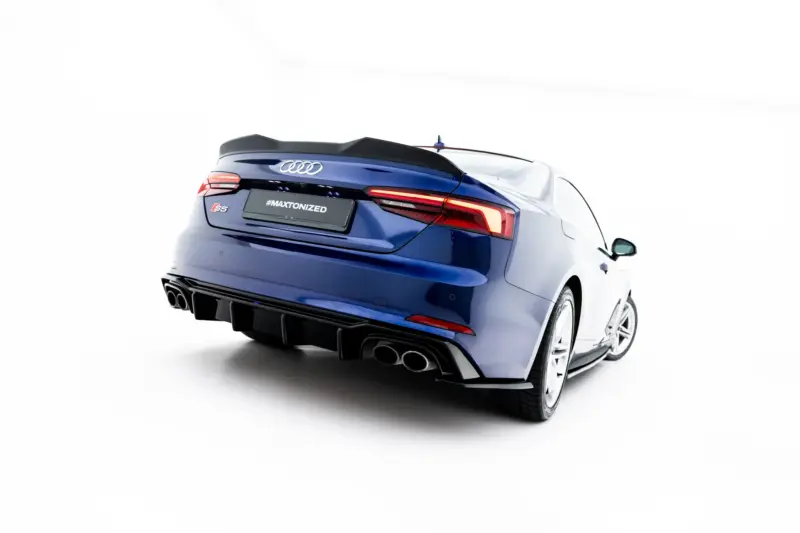 Rear three-quarter view of a blue Audi S5 convertible, featuring the spoiler, distinctive taillights, and quad exhausts