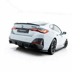 White BMW M440i viewed from the rear-left, featuring a carbon rear diffuser and red LED taillights on a white studio background.