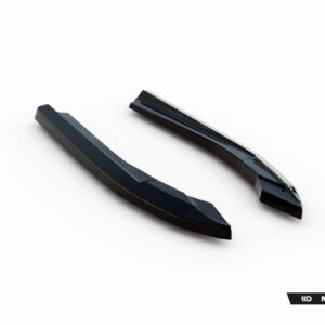 Pair of glossy black automotive aero parts (splitters/spoilers) on a white studio backdrop, Maxton Design branding visible at the bottom right.