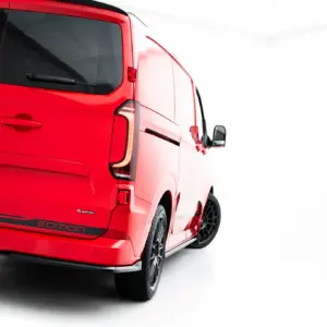 Rear three-quarter view of a red Volkswagen Transporter van, showing the VW logo, rear doors, tinted windows, and 'Edition' badge near the bumper.