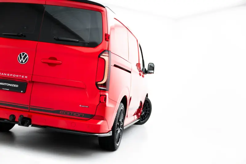 pol_po_Rear-Side-Splitters-Volkswagen-Transporter-T7-23936_3webp - OPSHOLDERS Rear three-quarter view of a red Volkswagen Transporter van, showing the VW logo, rear doors, tinted windows, and 'Edition' badge near the bumper.