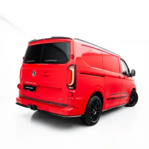 Red VW Transporter van photographed in a white studio, viewed from the rear-right side