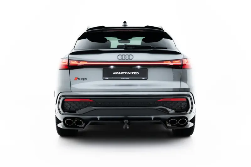 Rear view of a silver Audi SQ5 showing slim LED taillights, badge, and dual exhausts with a #MAXTONIZED plate.