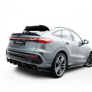 Rear three-quarter view of a silver Audi SUV with a rear spoiler and red taillights against a white background.