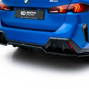 Blue car rear end with BMW badge, red taillights, and a Maxton Design license plate; showing the bumper and rear wheel area.