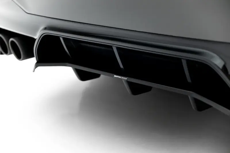 Close-up of a car's rear diffuser with dual exhaust tips and Maxton Design branding on the aero lip.