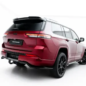 Rear three-quarter view of a red Jeep SUV showing taillights, large black wheels, and a rear spoiler against a white background. License plate reads '#MAXTONIZED'.