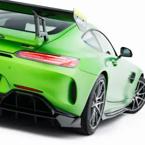 Rear three-quarter view of a bright green Mercedes-AMG GT R with a large rear wing and diffuser.
