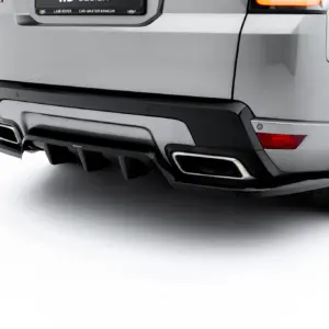 Rear view of a silver SUV showcasing the bumper, dual exhausts, and right taillight with tire visible on the side.