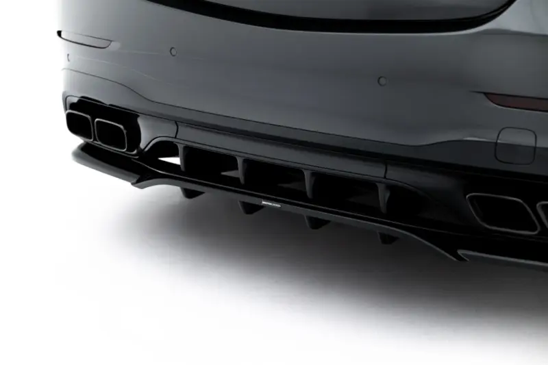 pol_po_Rear-Splitter-with-vertical-bars-Mercedes-AMG-C63-Sedan-Estate-W206-S206-23826_5webp - OPSHOLDERS Close-up of a dark car's rear bumper with dual exhaust outlets and diffuser surface details.