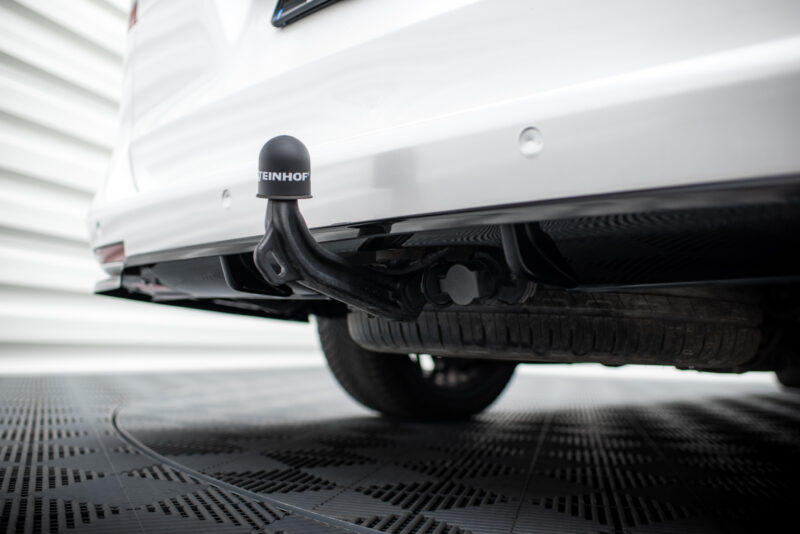 Close-up of a car's rear hitch with a black protective cap reading STEINHOF beneath the bumper