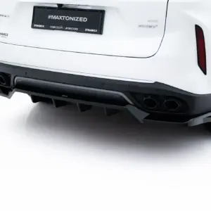 Rear view of a white car highlighting the quad exhausts and sporty diffuser with a large wheel visible on the right, license plate reads #MAXTONIZED.