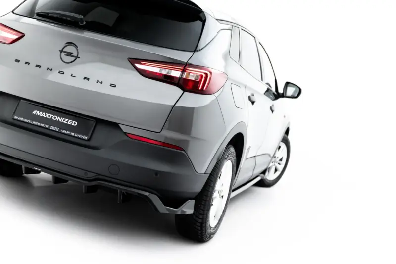 Rear three-quarter view of a silver Opel Grandland SUV, showing the brand badge and taillight details against a white background.
