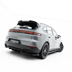 Rear three-quarter view of a silver Porsche Cayenne SUV with a spoiler, taillights, and exhaust tips, in a white studio background with a branded license plate reading '#MAYTONIZED'.
