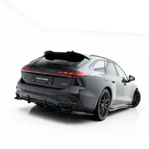 Rear three-quarter view of a dark gray Audi SUV in a white studio background, showing taillights and alloy wheels.