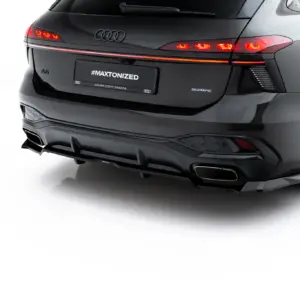Rear view of a dark gray Audi A6 with illuminated taillights, showing a license plate that reads #MAXTONIZED and a small Audi logo on the tailgate.