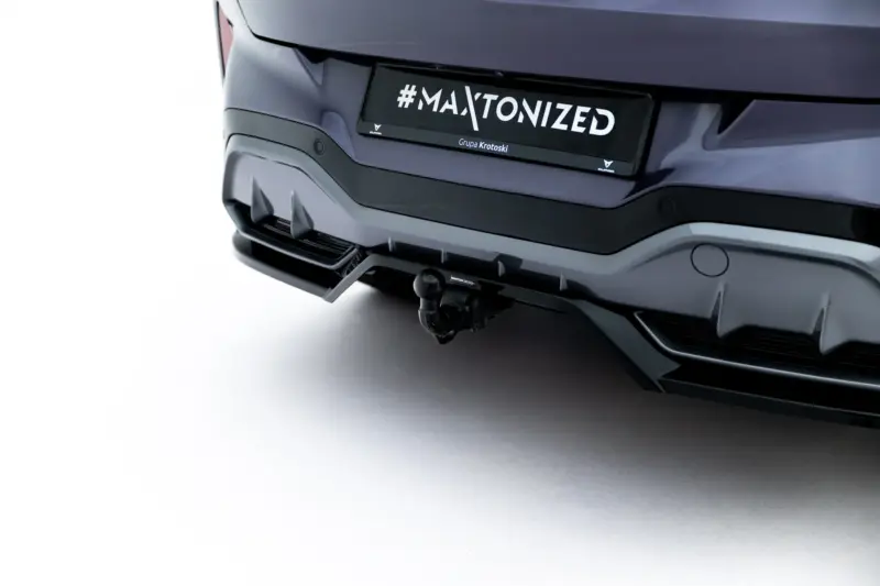 pol_po_Rear-Splitter-with-vertical-bars-V-3-Cupra-Terramar-Mk1-Version-with-towbar-23819_8webp - OPSHOLDERS Rear view of a dark SUV showing a custom license plate reading '#MAXTONIZED' with small brand logos nearby.