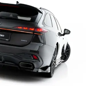 Rear view of a black Audi SUV with red taillights and '#MAXTONIZED' on the license plate.