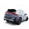 pol_po_Rear-Splitter-with-vertical-bars-V-4-Cupra-Terramar-Mk1-Version-with-towbar-23820_4webp - OPSHOLDERS Rear three-quarter view of a gray CUPRA SUV with red taillights and a black roof spoiler on a white background.