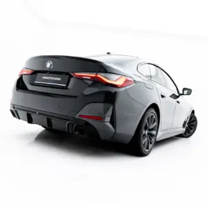 Rear three-quarter view of a dark gray BMW sedan in a white studio, showcased with glossy finish and prominent taillights on the back end.