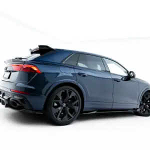 Blue luxury SUV shown from a rear-side angle with prominent taillights and large black alloy wheels in a studio setting.