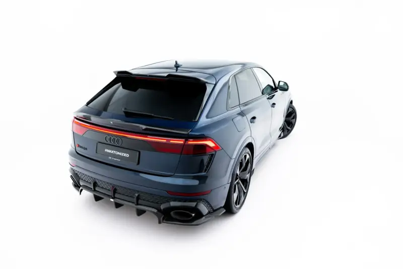 pol_po_Set-of-Prepreg-Carbon-Fiber-Splitters-Audi-RSQ8-Mk1-Facelift-23818_25webp - OPSHOLDERS Rear three-quarter view of a silver SUV with taillights lit, on a white studio background, emphasizing sleek design and roof spoiler.