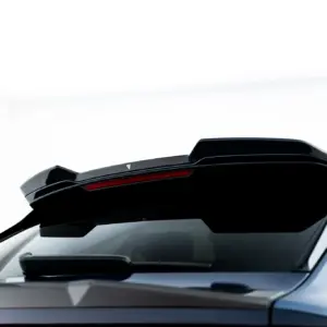 Close-up of the rear end of a white car, featuring a black spoiler and red taillight strip.