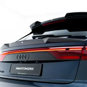 Rear view of a dark Audi SUV showing off its glossy tail lights, spoiler, and the '#MAXTONIZED' branding on the rear license area