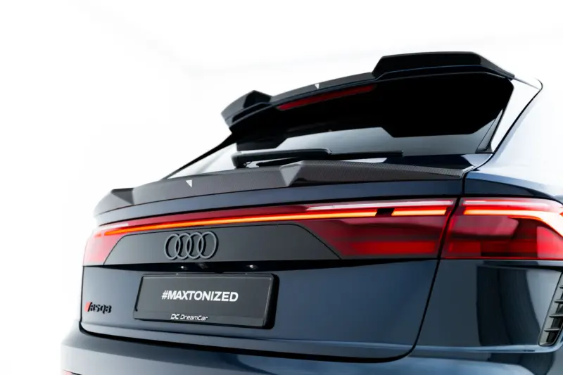 pol_po_Set-of-Prepreg-Carbon-Fiber-Splitters-Audi-RSQ8-Mk1-Facelift-23818_6webp - OPSHOLDERS Rear view of a dark Audi SUV showing off its glossy tail lights, spoiler, and the '#MAXTONIZED' branding on the rear license area