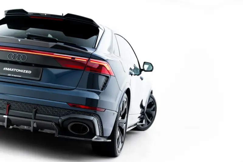 pol_po_Set-of-Prepreg-Carbon-Fiber-Splitters-Audi-RSQ8-Mk1-Facelift-23818_7webp - OPSHOLDERS Rear-right view of a dark Audi SUV, showing red taillights and a '#MAXTONIZED' plate (DreamCar branding) for a promotional car image.