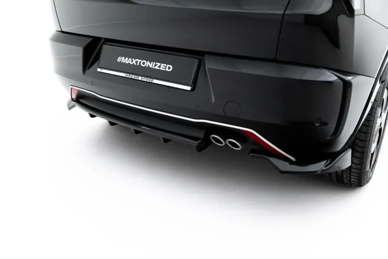 Rear view of a glossy black car with a license plate reading #MAXTONIZED and Gazda Group branding on the plate area.