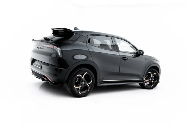 Dark gray luxury SUV shown from rear three-quarter view, highlighting the rear spoiler and oversized alloy wheels.