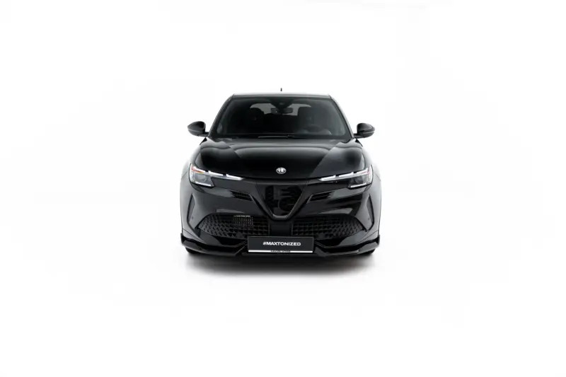 Front view of a glossy black car facing the camera, with visible grille, headlights, and side mirrors against a white studio background.