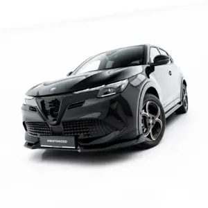 Front-left angled view of a sleek black car in a white studio setting, emphasizing its aggressive grille and low profile, with #MAXTONIZED on the plate.